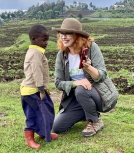 Woman shows child photo on phone.