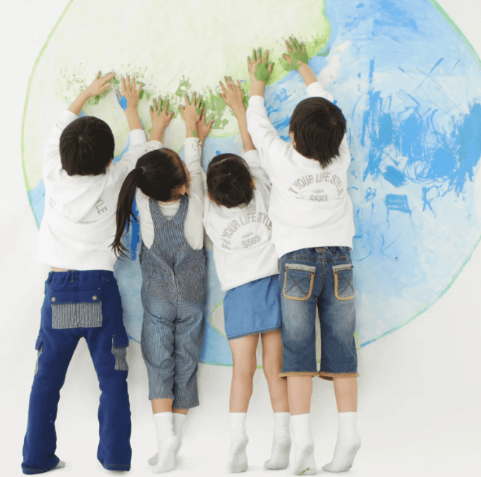 Children painting world map together.